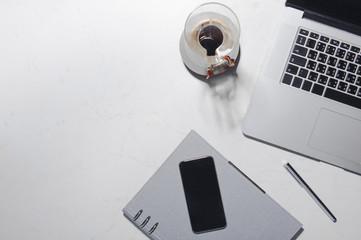 From above photo of coffee and laptop on business table.