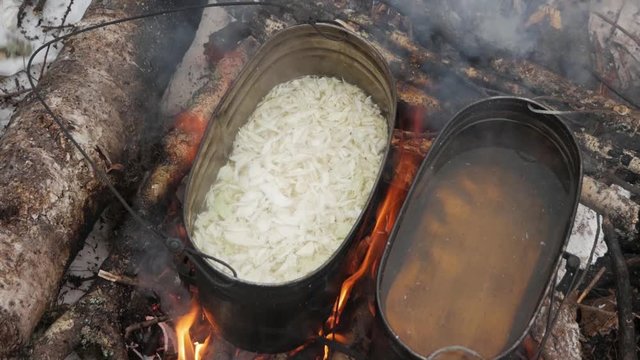 cooking in a cauldron on a campfire in nature