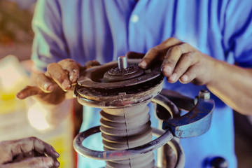 Focus selection : Mechanic inspects the bearings installed on the top of the car's chokes