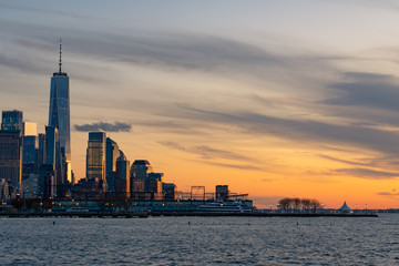 Fototapeta na wymiar Skyline of the New York City Financial District along the Hudson River during a Sunset