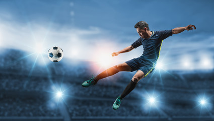 The concept of playing football.Soccer player kicks the ball on the soccer field.Professional...