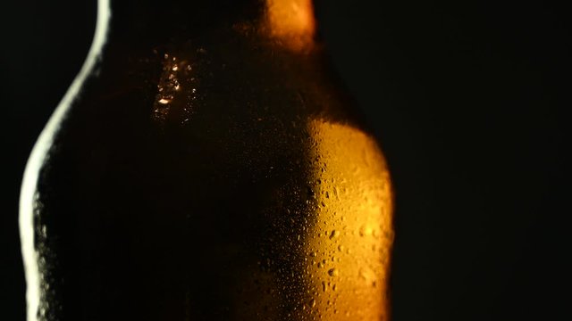 beer bottle with drops of water spins
