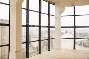 Panoramic Windows overlooking the city, garland, wooden floor