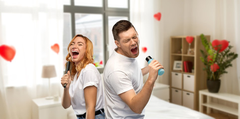 valentine's day, fun and people concept - portrait of happy couple in white t-shirts couple singing...