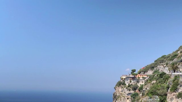 Locked Off View Of Cliff Side Next To Expanse Of Blue Sky And Ocean In Amalfi Coast, Italy