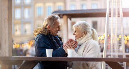 Happy senior couple having fun on the Christmas Market