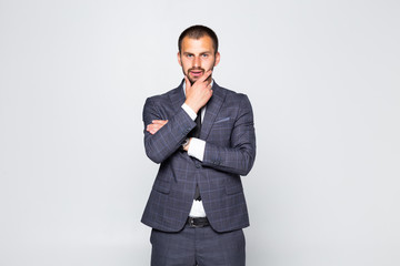 Young handsome man in suit and glasses looking at copy-space thinking or dreaming isolated on white background