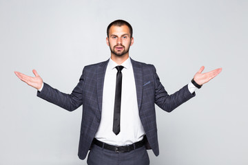 Young happy businessman gesturing with hands and showing balance