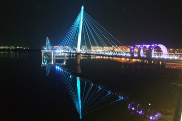 Night view of a beautiful scene of bridge over sea water in the evening time.