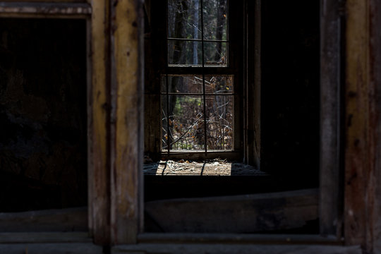 Window with bars in a dark abandoned room