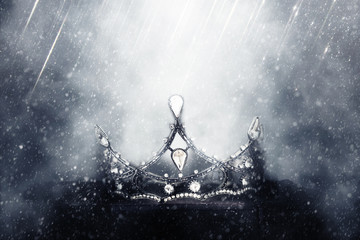 mysterious and magical photo of of beautiful queen/king crown over gothic snowy black background. Medieval period concept