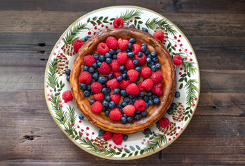 Raspberry and blueberry cheesecake on a holiday platter