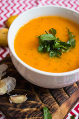 Orange hot pumpkin lentil soup in bowl. Spicy creamy soup with pumpkin puree.