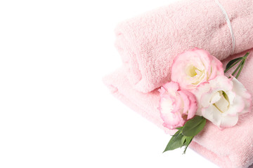 Pink towels and flowers isolated on white background