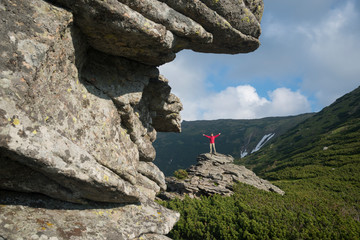 Naklejka premium Woman among the majestic mountains