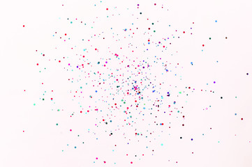 Glitter flying sparkles on pink pastel trendy background. Festive backdrop for graphic design projects.