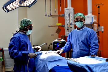 Surgical light in the operating room. Preparation for the beginning of surgical operation with a cut. The surgeon is performing surgery on the patient. 
