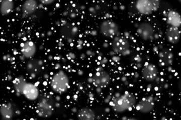 Texture of white snow blurry bokeh isolated black background. falling snow overlay. star sky. Black spots on white background, white drops and spots