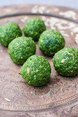 Spinach green vegan balls. Pkhali - Georgian traditional cold snacks with spinach and walnuts.