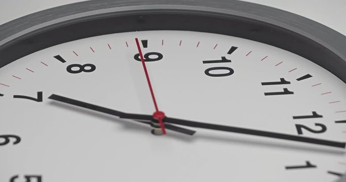 Truck shot of time-lapse gray clock with black arrows shows motion the time speed up from 7.00 a.m. to 8 a.m., How time flies concept.
