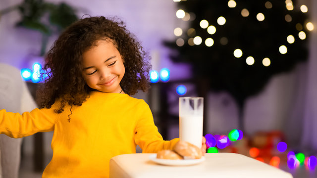 Cheerful African American Girl Preparing Treat For Santa Claus