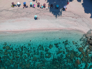 Epic turquoise colored water on a beautiful beach in Greece. Drone shot.