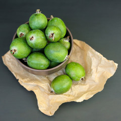 Feijoa green on black background. Feijoa Sellova is a fruit crop from tropical regions. Organic agricultural fruit, healthy food concept, eco-friendly natural products, vegetarian, raw harvest