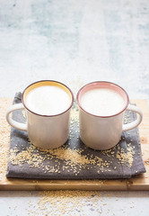 Plant milk. Plant based non-diary milk healthy vegan drink with sesame seeds in cup or mug. No milk diary