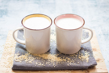 Plant milk. Plant based non-diary milk healthy vegan drink with sesame seeds in cup or mug. No milk diary