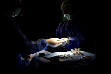 Team surgeon at work in operating room. Surgical light in the operating room. Preparation for the beginning of surgical operation with a cut