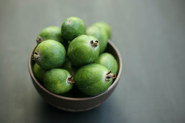 Feijoa green on black background. Feijoa Sellova is a fruit crop from tropical regions. Organic agricultural fruit, healthy food concept, eco-friendly natural products, vegetarian, raw harvest