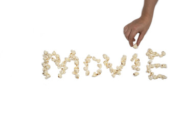 popcorn isolated on white background forming the word Movie with hand holding popcorn