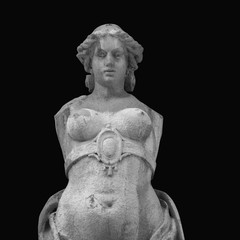 The goddess of love in Greek mythology, Aphrodite (Venus in Roman mythology) Fragment of ancient statue against black background. © zwiebackesser