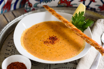 Turkish Red Lentil, Rice and Bulgur Soup Garnished with Lemon Wedge, Ezogelin Corbasi.