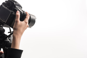 cropped view of professional photographer working with digital camera isolated on white - obrazy, fototapety, plakaty