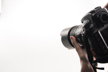 cropped view of photographer working with digital camera isolated on white - Powered by Adobe