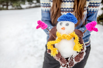 Funny winter woman with snowman