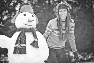 Fototapeta na wymiar Funny winter woman with snowman
