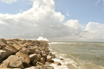 Fototapeta na wymiar Breakwater with roughened sea