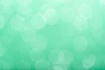 green bokeh from tree, green background.