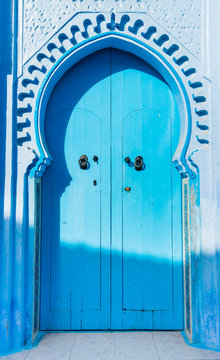 Blue moroccan door in Chefchaouen town with traditional ornaments
