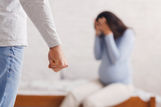 Scared pregnant lady suffering from domestic violence of her husband
