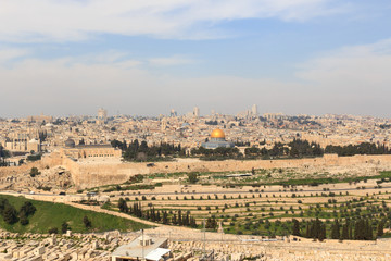 Mount of Olives Jewish Cemetery and Jerusalem Old city cityscape panorama with Dome of the Rock with gold leaf and Al-Aqsa Mosque on Temple Mount and Rotunda of Church of the Holy Sepulchre, Israel