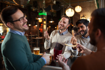 People in pub drinking beer and have a fun