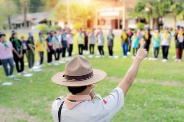 The Scout director is teaching activities in the middle of the lawn.