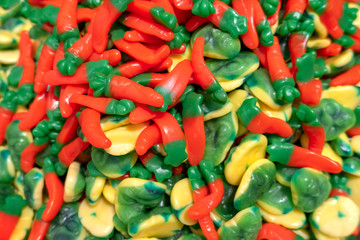 top view chewy marmalade in the form of carrots and alien heads on the counter in the candy store