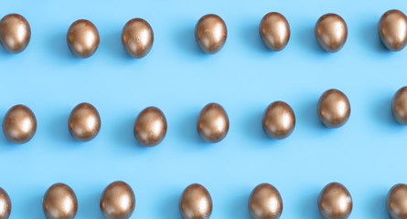 Background with Easter eggs in gold color.