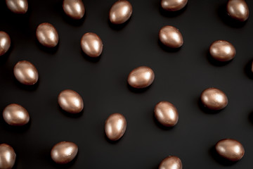 Background with Easter eggs in gold color.