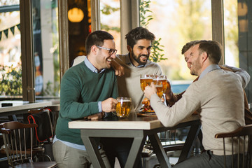 Friends in pub,drinking beer and have a fun