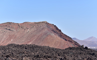 Fire Mountains and volcanic lava stone in Timanfaya National Park, Lanzarote, Canary Islands, Spain